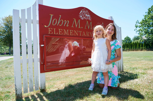 Vanessa Gordon and her daughter standing out in front of an elementary school in the Hamptons